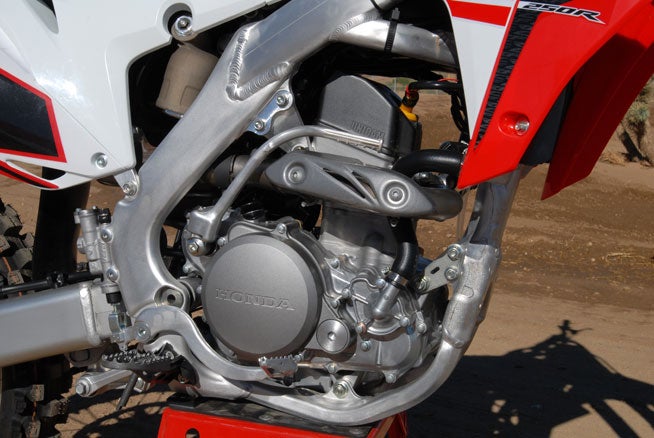 The CRF250R's fuel-injected four-stroke single is now easier than ever to tune to track conditions, thanks to a new Engine Mode Button feature that allows the rider to switch between three different EFI/ignition maps to suit track conditions.