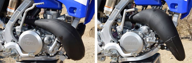 The YZ250 motor with its low-boy pipe is on the left, while the YZ125 with its more upward-routed pipe is at the right. Both machines still rely on good old-fashioned carburetors to deliver their premix through reed valves and into their respective combustion chambers. A Yamaha Power Valve System alters the exhaust port to broaden the powerband on both machines. 