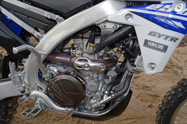 The WR boasts the same 77.0 x 53.6mm bore and stroke as the YZ250F for quick-revving power, but its ECU mapping is adjusted for better low-end and mid-range torque. Electric starting and a new six-speed transmission are part of the WR's signature features.
