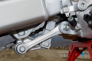 Longer pull rods (dog bones) and a revised delta link give the CRF's Pro-Link linkage ratio a more linear curve that helps plant the bike better during hard acceleration.