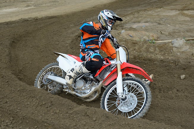 Braking at high speeds into a corner can sometimes make the CRF's steering just a little twitchy. In addition to its standard HPSD steering damper, the CRF250R now has 5mm longer fork legs, which can be lowered in the triple clamp to effectively slow the steering down and increase stability even more. Many riders won't need to even make a ride height change, but faster riders and/or tuning freaks will appreciate it.