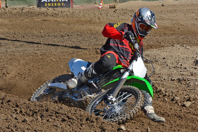 The KX's deliberate steering forces the rider to be aggressive to keep its front end tracking through rutted corners. In flat or semi-banked turns, steering with the throttle is a viable option.
