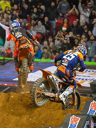 Musquin (right) gets loose and goes off the track while Dungey (left) takes over the lead and goes on to victory. Musquin later claimed that Stewart had caused the incident by failing to get out of the way for the leaders.