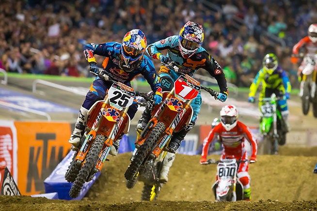 Ryan Dungey (1) grabbed the Detroit Supercross main event lead early and appeared well on his way to his 28th career 450cc supercross win, but he was penalized for jumping in area where the medical flag was being shown and was credited with third. Marvin Musquin (25) crashed on the last lap and crossed the line third, only to be bumped up to second in the aftermath. PHOTO BY RICH SHEPHERD.