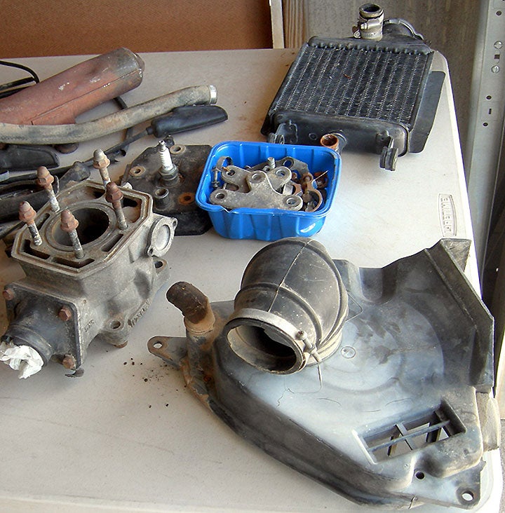 Here are some of the parts that came along with our 1982 Yamaha YZ125's carcass. In our zeal to buy the bike, we only realized afterward that its exhaust pipe was missing. Bummer.