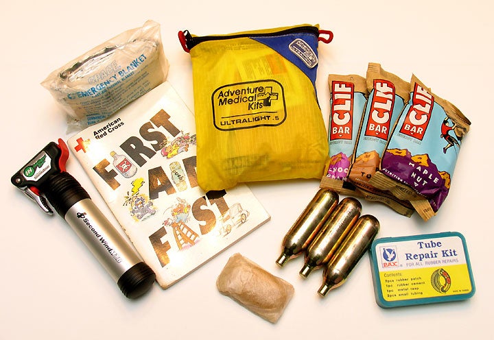 Here’s what the author carries in his Camelbak Lobo (in addition to 70 oz. of Gatorade). That’s a foil-like emergency blanket in the pouch at upper left. That little blob at the bottom is a bar of hotel soap wrapped in plastic.