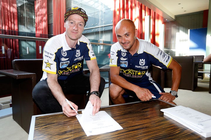 Graham Jarvis (left) is shown here signing a contract extension that will see him remain on the Rockstar Energy Husqvarna Factory Racing off-road team through 2018.