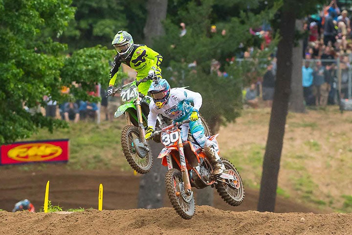 Austin Forkner (214) battles with Shane McElrath (30). Monster Energy/Pro Circuit/Kawasaki's rookie rider finished third overall. PHOTO BY RICH SHEPHERD.