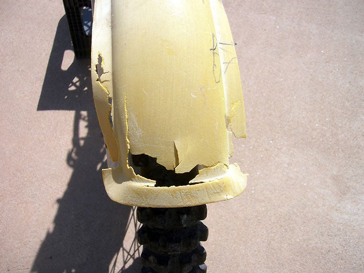 Front fender any good? Not this one. Time for a replacement. The front number plate/radiator cover is also beyond saving. The list grows longer. 