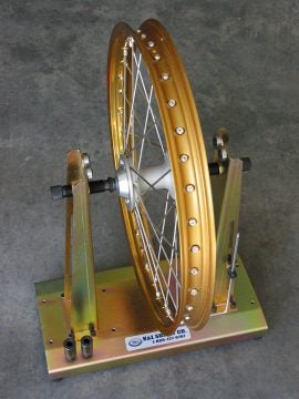 This truing stand from K & L Supply is a good value; it can be used as a balance stand as well. Notice the armature stored on the right-side support.