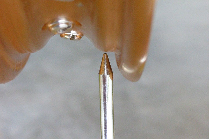 Here the armature is set to measure north-south (vertical) runout. Notice that the reading is taken from a horizontal surface on the rim, rather than at the edge of the flange. This keeps variations in flange shape out of the equation.