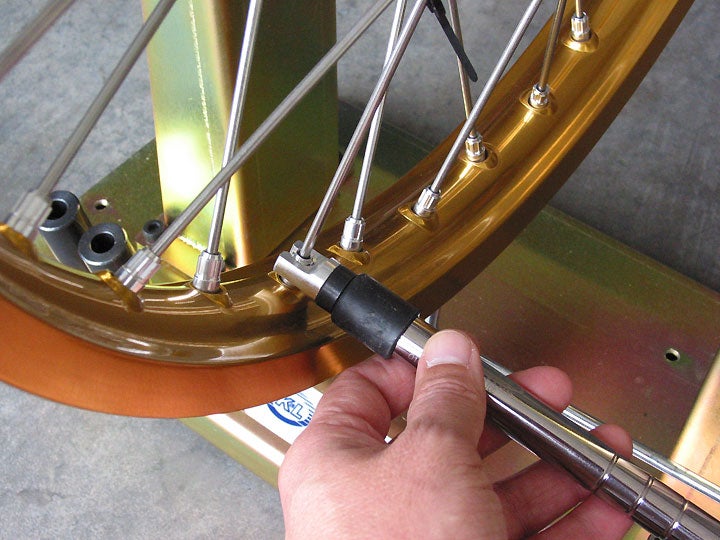 During the tightening process, a proper spoke torque wrench is helpful for obtaining the greatest degree of accuracy, but it isn't necessary. Tightening the spokes uniformly to obtain the same pitch when struck with the spoke wrench is an adequate technique.