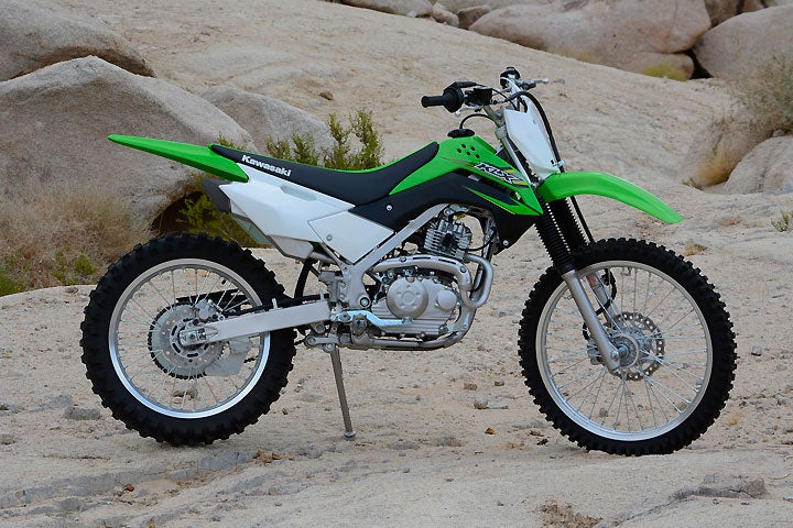 The KLX140G uses the same steel perimeter chassis as the KLX140L, but the G model's larger 21-inch front and 18-inch rear wheels give it a taller seat height and more ground clearance.