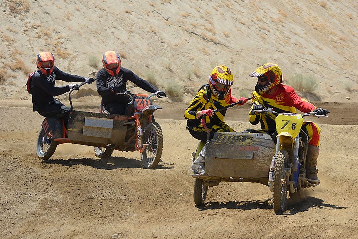 Sidecarcross racers are a tight-knit family, and they don't get any closer than this group. Ace Kale (right) shouts instructions at his newbie passenger, daughter Kellie, while trying to keep son Kevin and passenger Mike North (left) at bay.