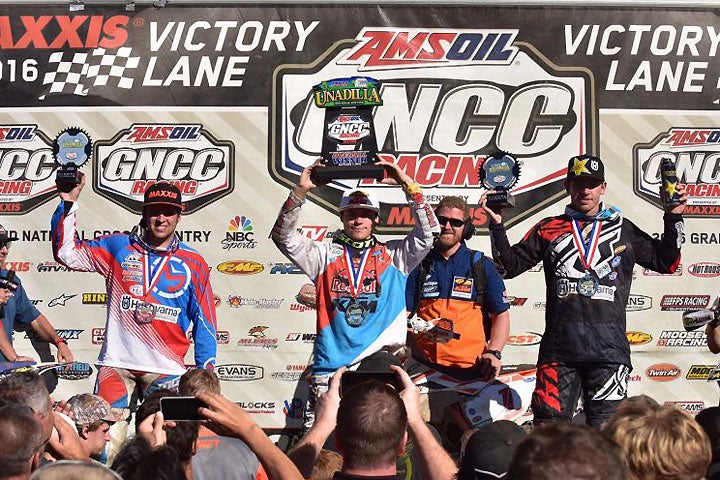 (Left to right): Runner-up Strang, winner Russell and third-place finisher Thad DuVall celebrate on the Unadilla GNCC podium. PHOTO BY KEN HILL.