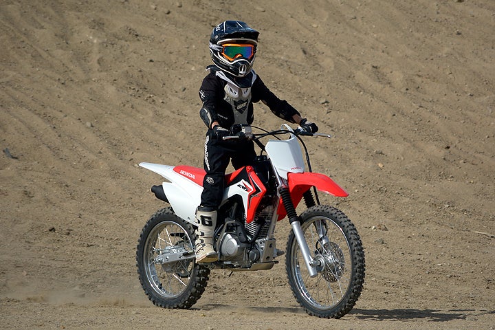 Guest tester Jett Lessing takes a spin on the Honda CRF125F. Already an off-road champion at age 10, Lessing liked the Honda's ergonomics, which favor smaller riders.