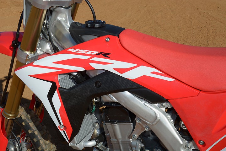 Longtime CRF450R customers can say goodbye to snagged boots and knee guards. The new CRF features narrower radiators and tucked-in shroud, giving the bike a smaller, narrower ergonomic feel.