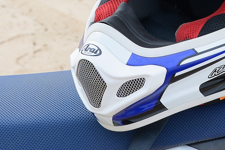 The VX-Pro4's chin bar is designed to be close to the rider's face in order to meet Arai's round profile standards for the helmet. The ventilation grills at the front of the helmet are designed to pop out in the event of a crash. 