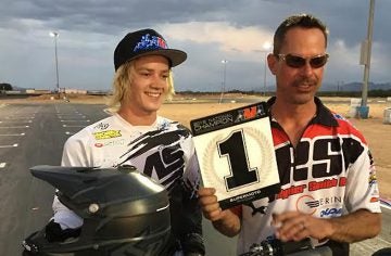 Gage McAllister (left) accepts his number one plate for winning the Open class of the 2016 Supermoto Championship.