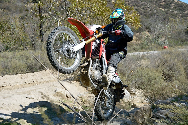 You can loft the wheel on the CRF250L but only with the aid of the clutch. While the Honda's engine is smooth and it's fuel-injection crisp and clean, the engine lacks low-end punch.