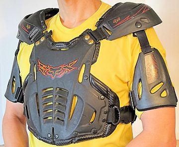 Chest protectors like this Fox Racing unit offer a layer of protection to the upper torso. Many also feature back armor to help protect the ribs and spine. Wearing this gear over or under the rider's jersey is a subjective choice.