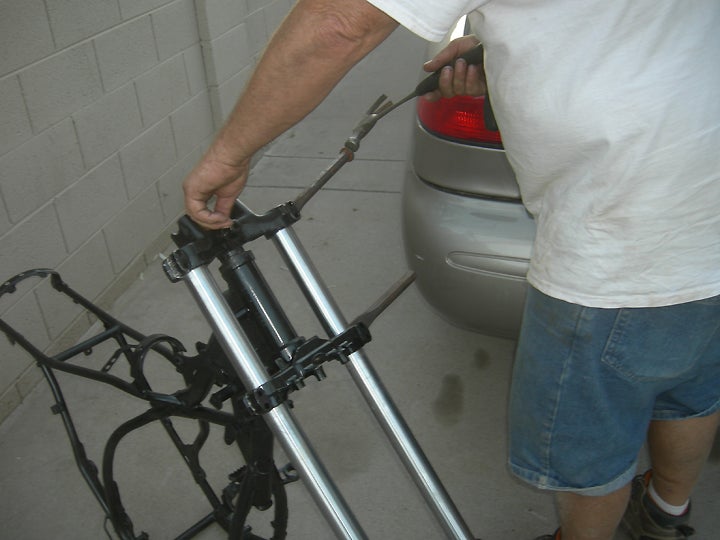 It was necessary to use a pair of stout chisels to spread the triple clamps far enough apart to get the fork legs installed.