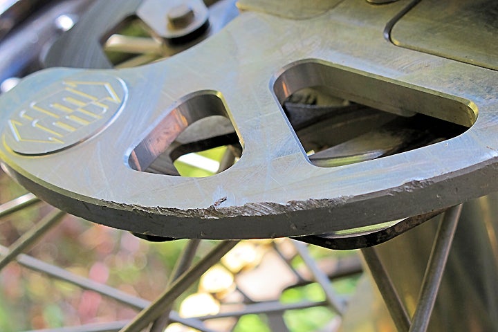 Check out the rock rash on this brake disc guard. Would you rather that was what your brake rotor looked like instead? PHOTO BY MARK BARNES.