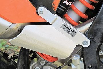 Four-stroke pipes require less protection help, but this guard from Flatland Racing not only protects the muffler, it also shields the rider from exhaust heat. PHOTO BY MARK BARNES.