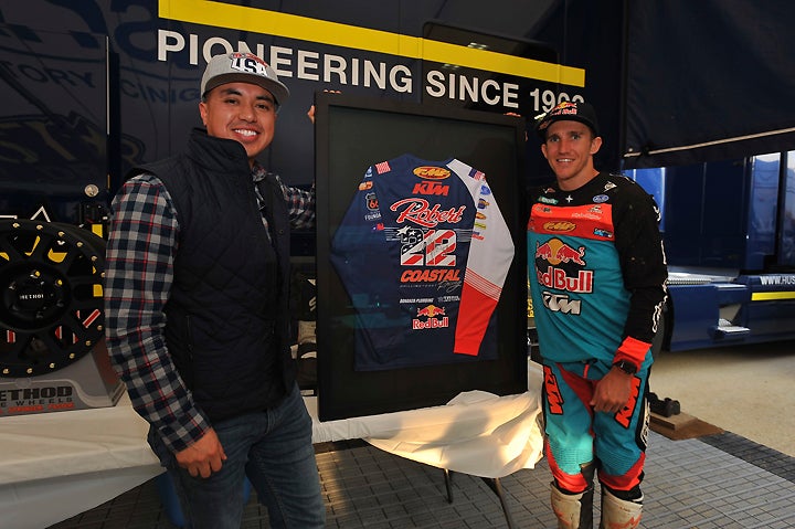Angel Uruchima (left) finished up his graduate degree in New York on Friday, hopped a red-eye and made it to the Ride Day in time to place the winning big of $2600 for a framed, signed jersey that Taylor Robert (right) used in helping lead the U.S. World Trophy team to victory in Spain. PHOTO BY MARK KARIYA.