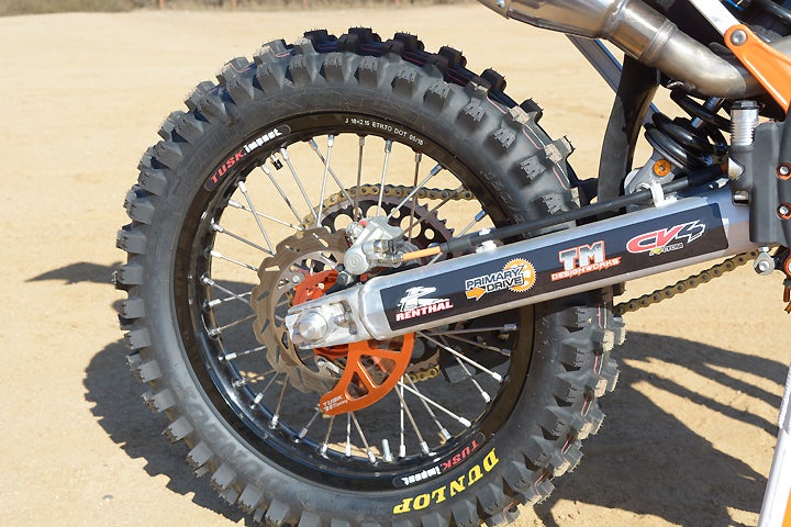 Dunlop AT-81 tires ride on a complete Tusk Off-Road wheel set. The rear disc is protected by a Tusk Off-Road billet disc guard.