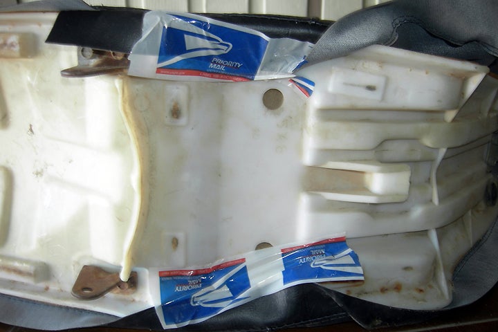 Taping the sides of the saddle helped to keep the cover aligned during the process. Any tape will work. As you can see, the United States Postal Service is still good for something.