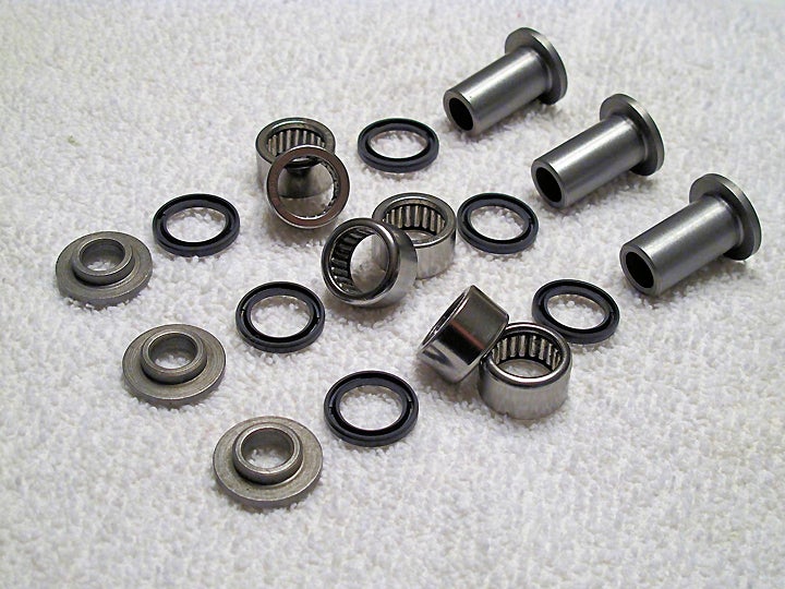 We decided to service our sample machine's linkage bearings using an All-Balls needle bearing kit. This kit includes all the bushings, seals and bearings shown here for our example bike, along with the lower shock joint and its seals (not shown), which we deemed unnecessary at this point and saved for the future.